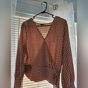 Red black and beige patterned top